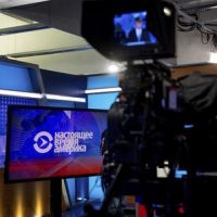 Current Time America news anchor Ihar Tsikhanenko, right, prepares for a broadcast in the offices of Voice of America in Washington, Wednesday, Feb. 8, 2017. Two U.S. government-funded news outlets are launching Current Time, a global Russian-language TV network aimed at providing an alternative to slick, Kremlin-controlled media that critics say spread propaganda and misinformation. (AP Photo/Andrew Harnik)